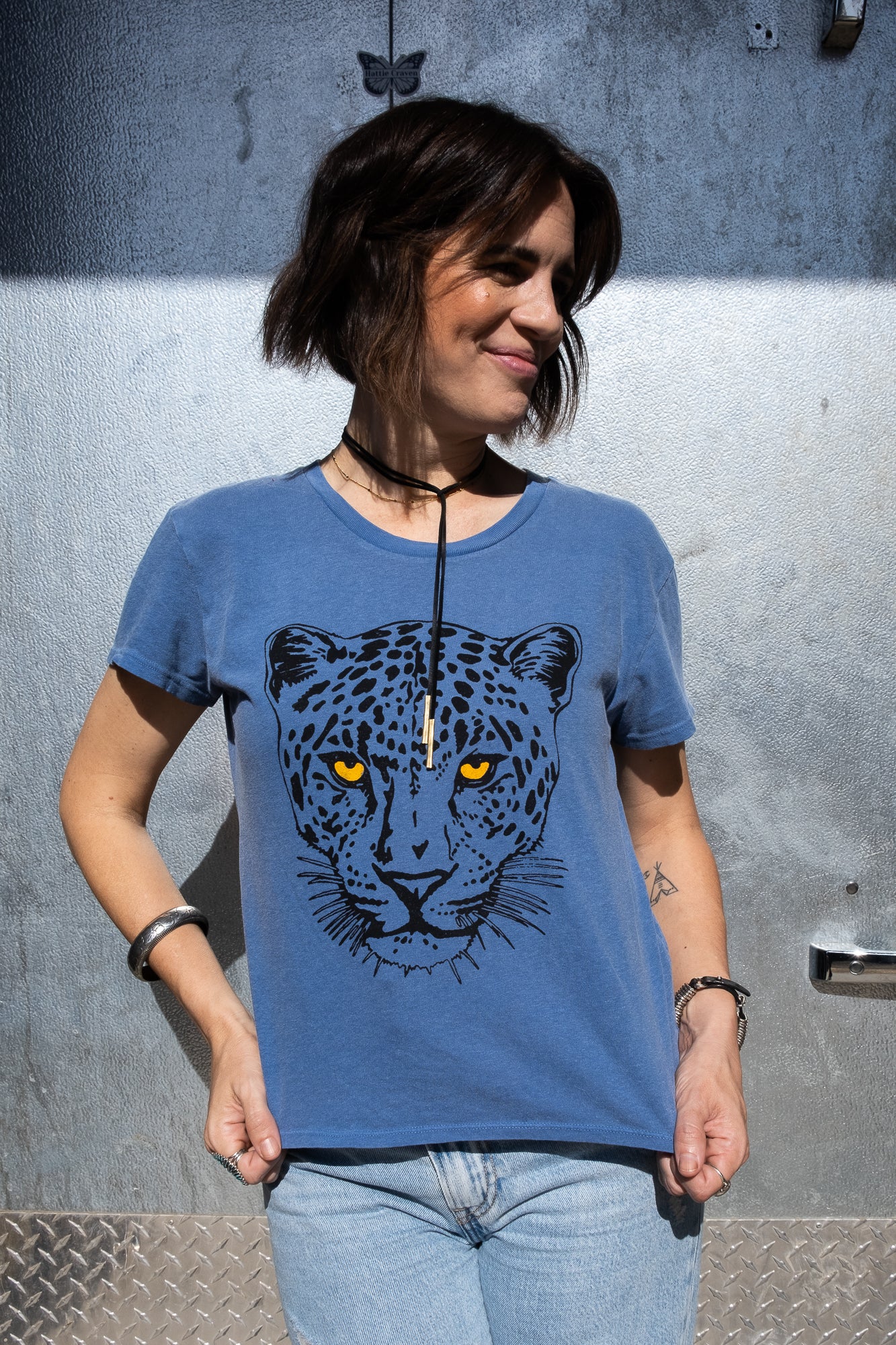 Women's Snow Leopard blue boxy graphic tee styled on model - front view.
