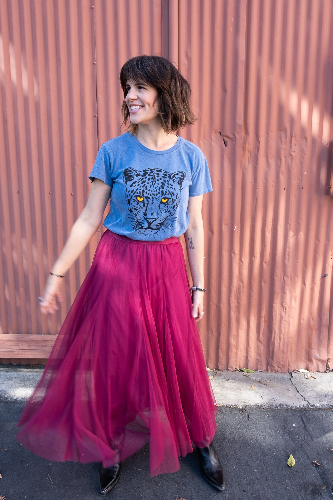 Women's Snow Leopard blue boxy graphic tee styled with a skirt.