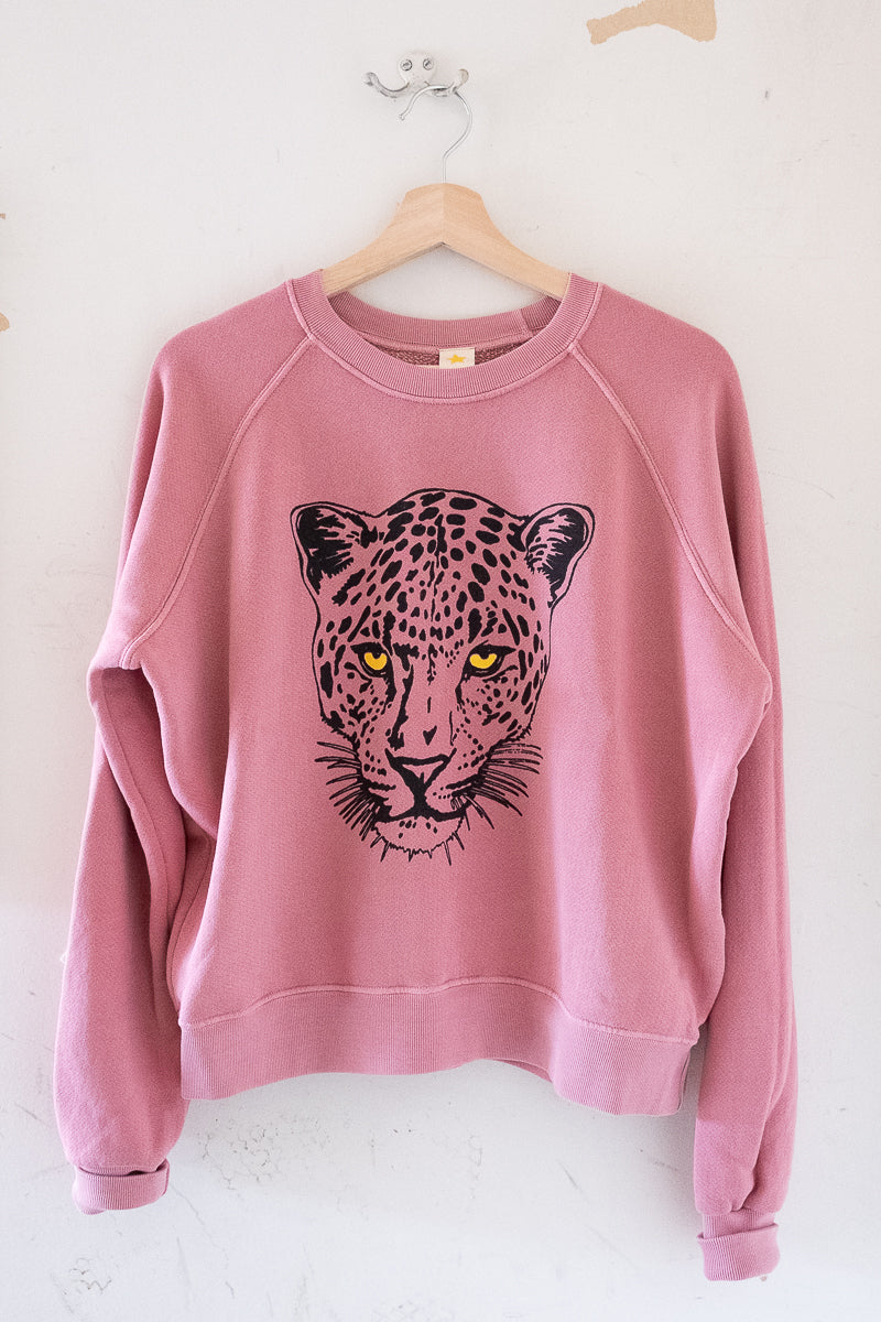 Women's vintage washed sweatshirt in pink - hanging detail view.