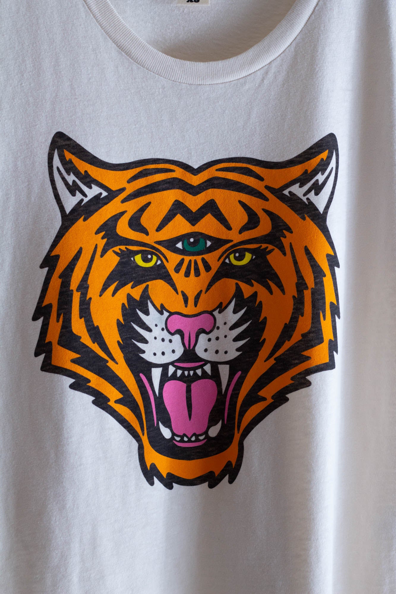 White women's graphic tee with a tiger graphic.