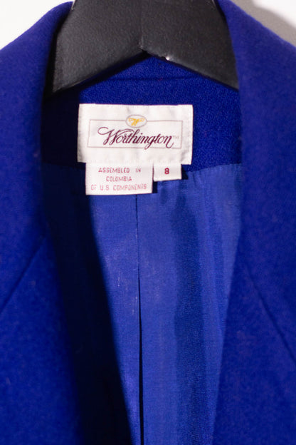 Close-up of a blue coat with a label on a white background